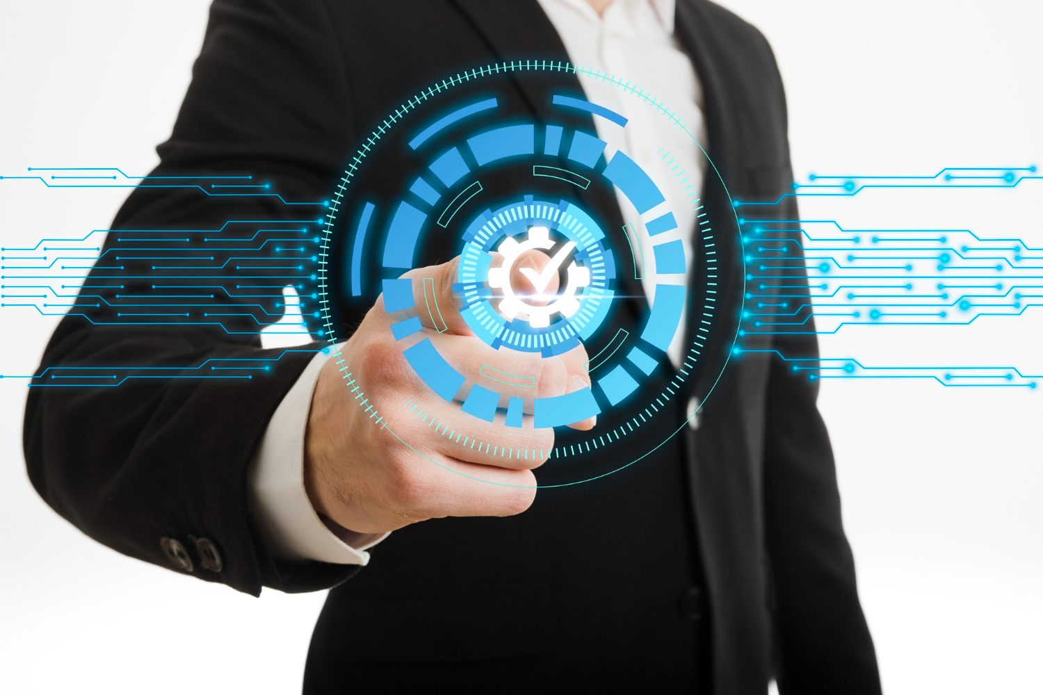 A man in a suit and tie pointing to an image of a circuit board.